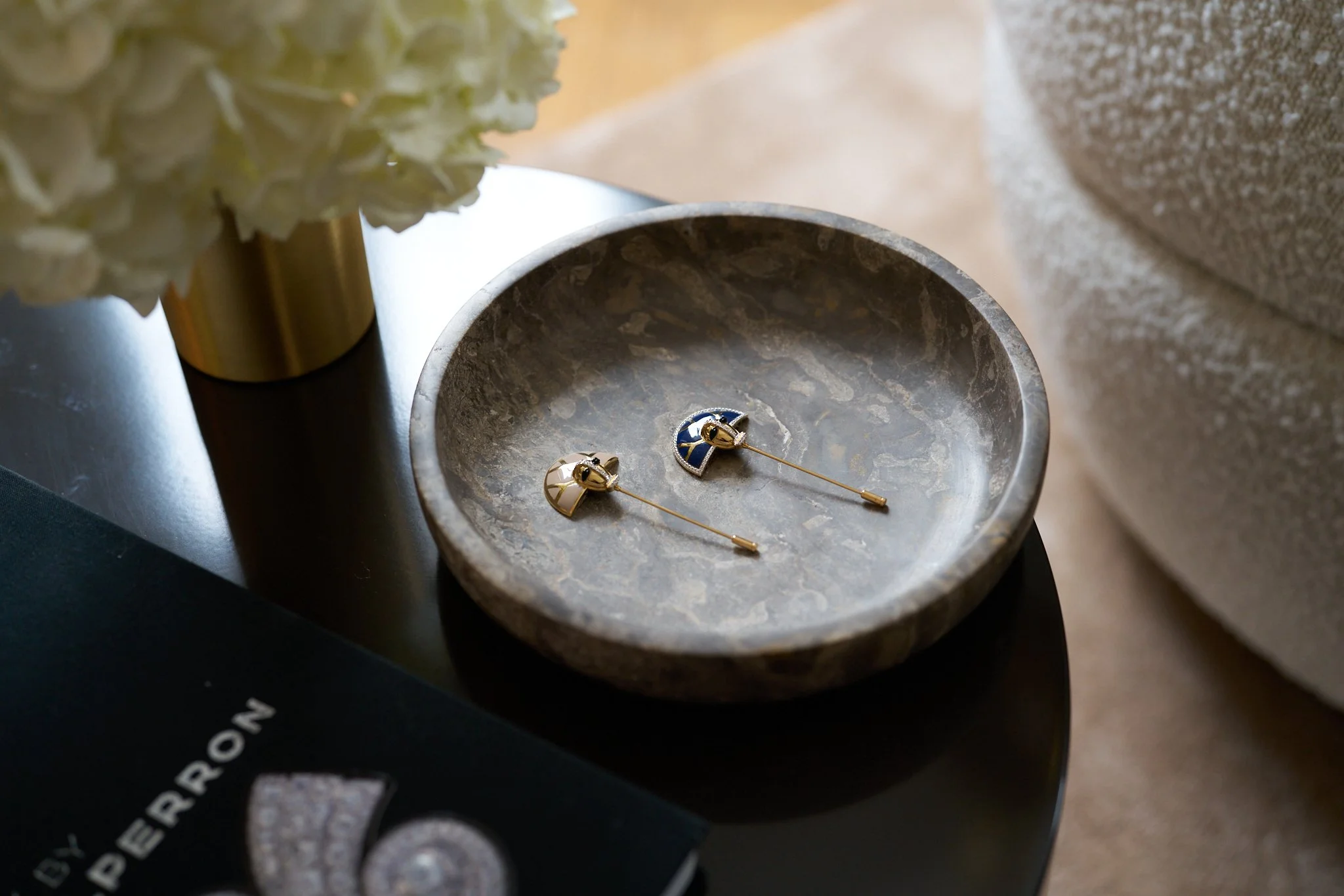 Fine jewellery arranged in a sculptural bowl within the boutique