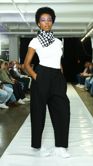 CGT runway look with a monochrome scarf and wide-leg black trousers