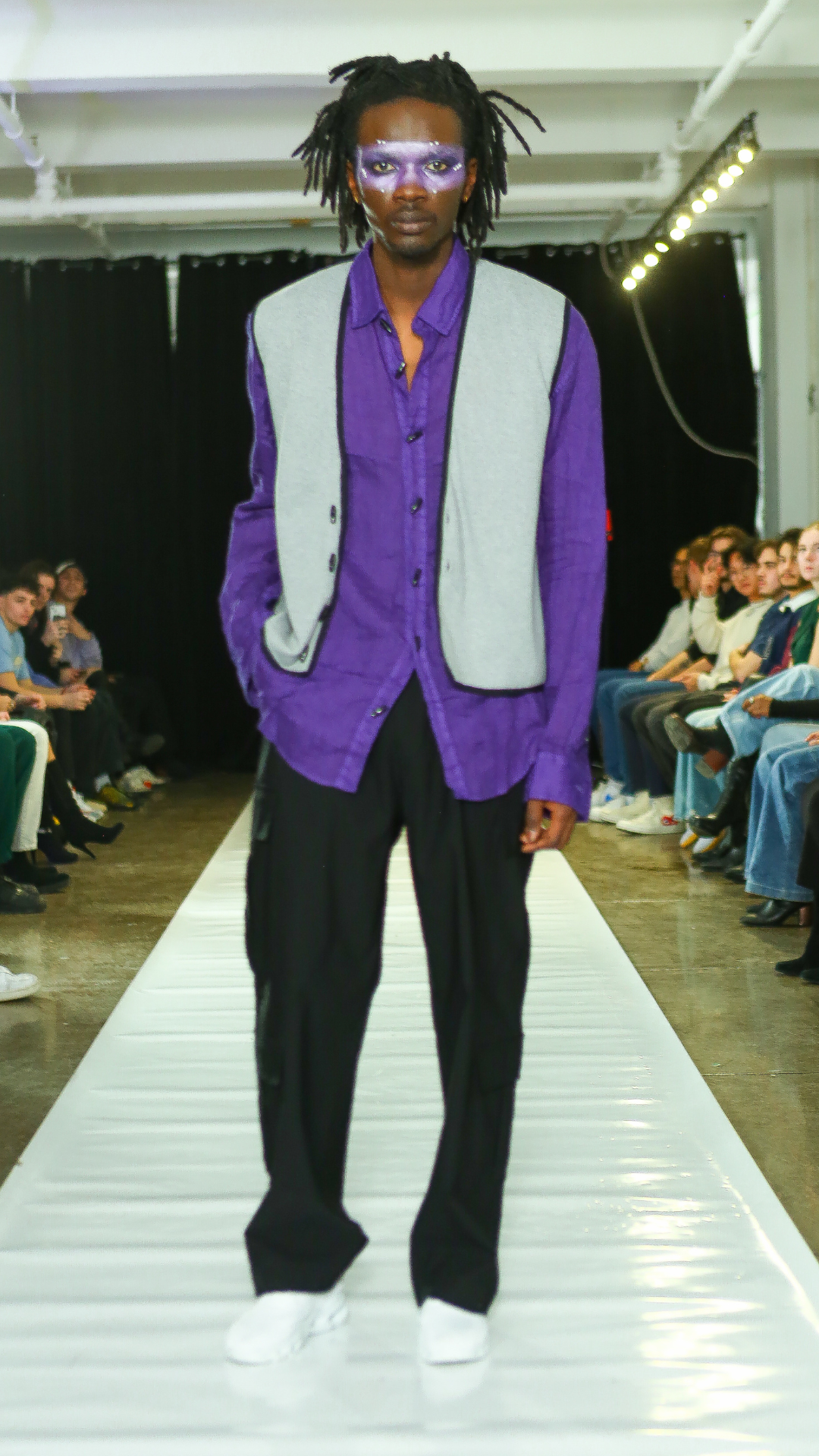 CGT runway look with a purple shirt and grey sleeveless layer