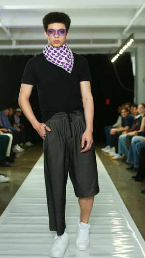 CGT runway look with a purple heart-print scarf and dark separates