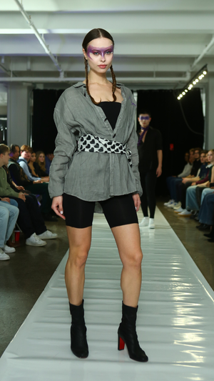 CGT runway look with a grey jacket and patterned waist detail