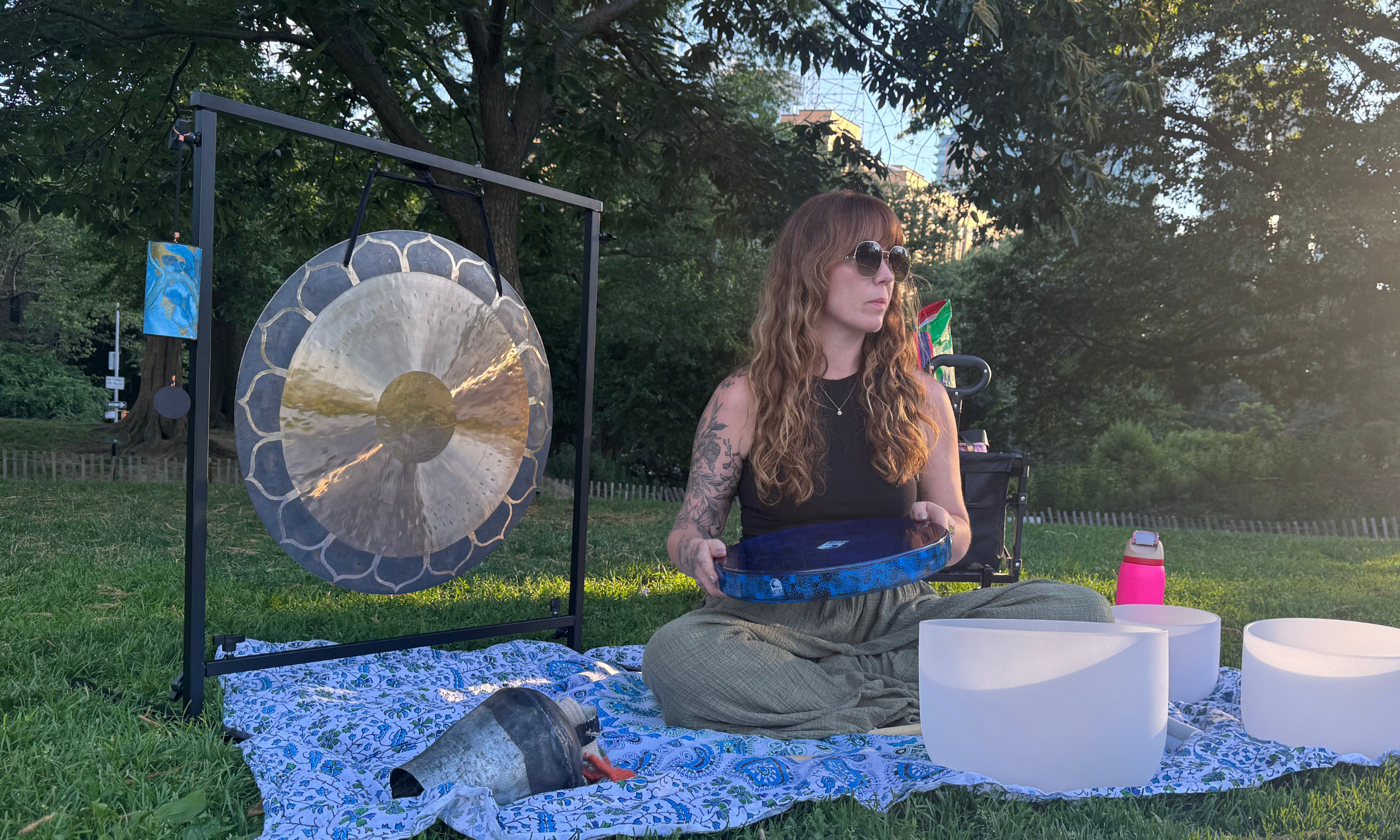 Tabitha Anderson playing sound healing instruments in a park in Fort Greene, Brooklyn.