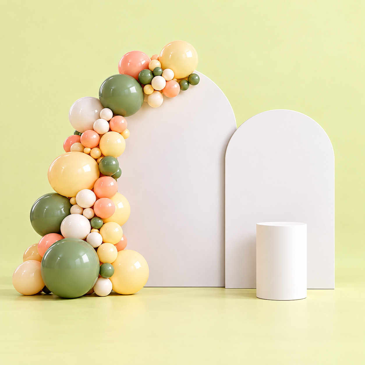Decorative display with pastel-colored balloons arranged on and around white geometric shapes, set against a light green background.