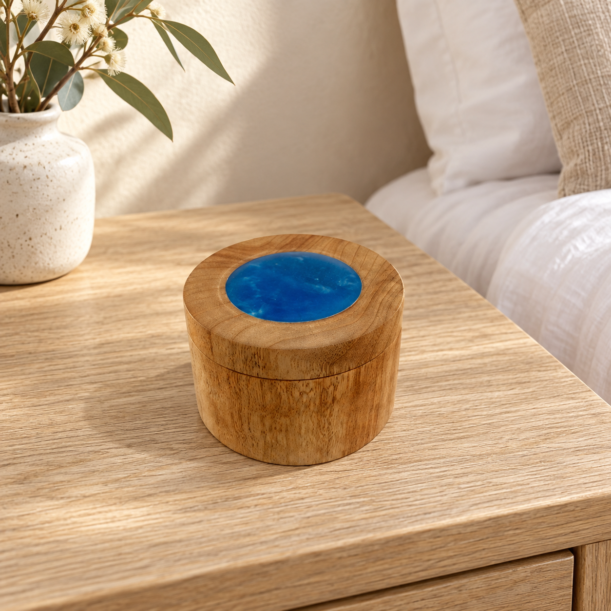 Camphor Laurel and blue resin trinket box displayed on a bedside table