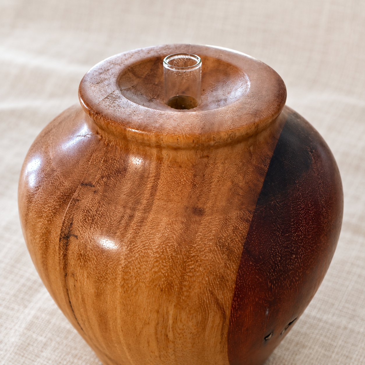 Close-up of the vase’s contrasting Spotted Gum and Red Gum grain, gloss varnish, turned rim and glass tube insert.