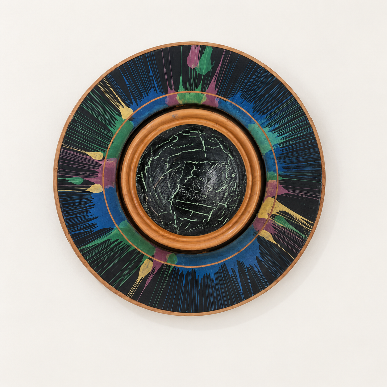 Circular Silky Oak timber wall art with colourful radiating lines and a raised crackle-pattern centre