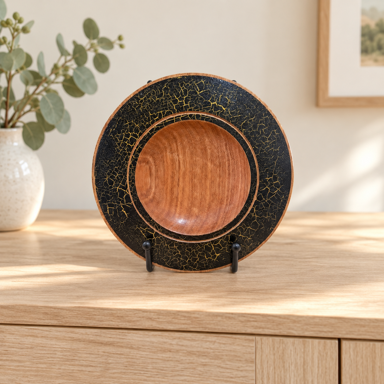 Silky Oak black and gold decorative plate displayed on a timber country cabinet