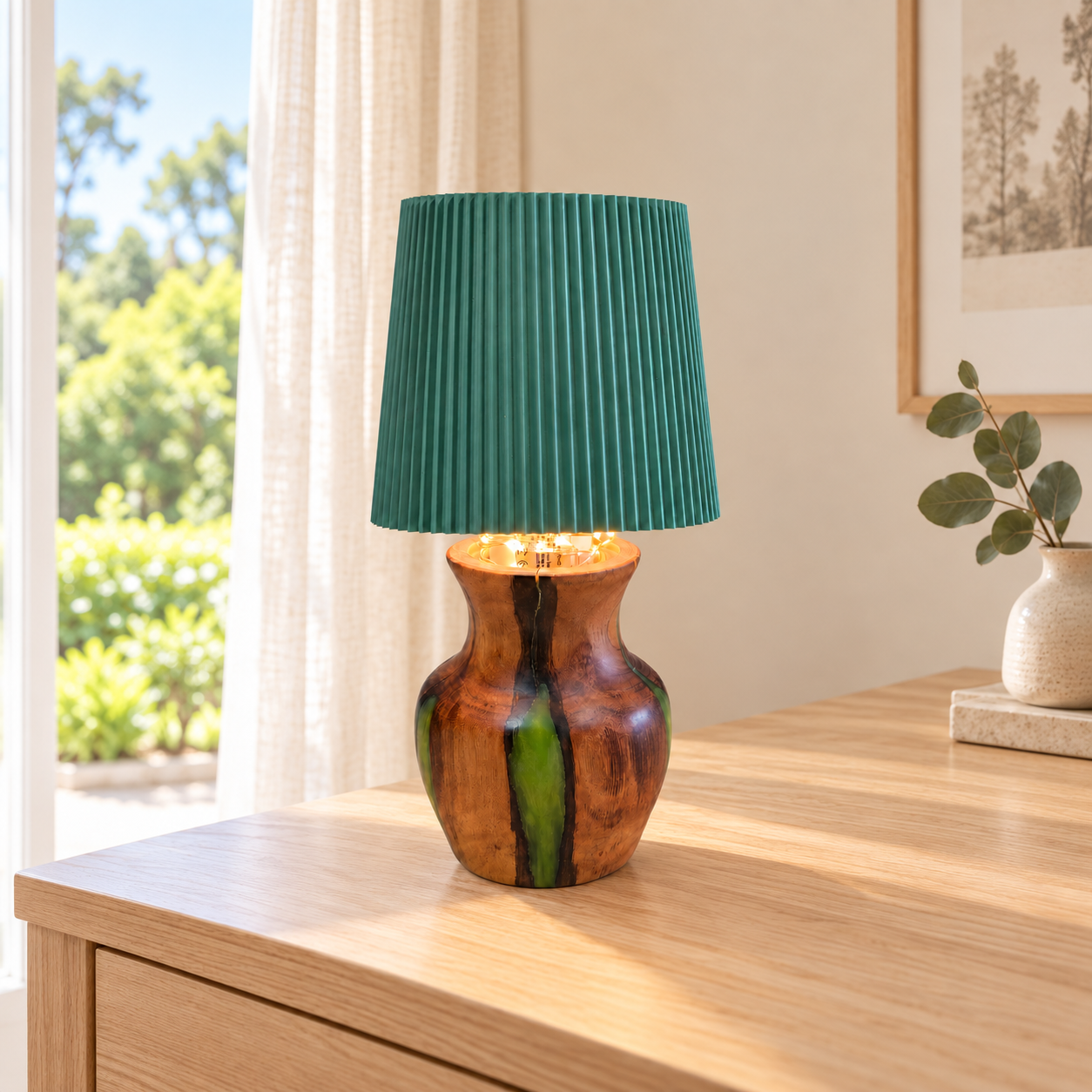 Australian hardwood and emerald green resin table lamp on a timber table beside a window.