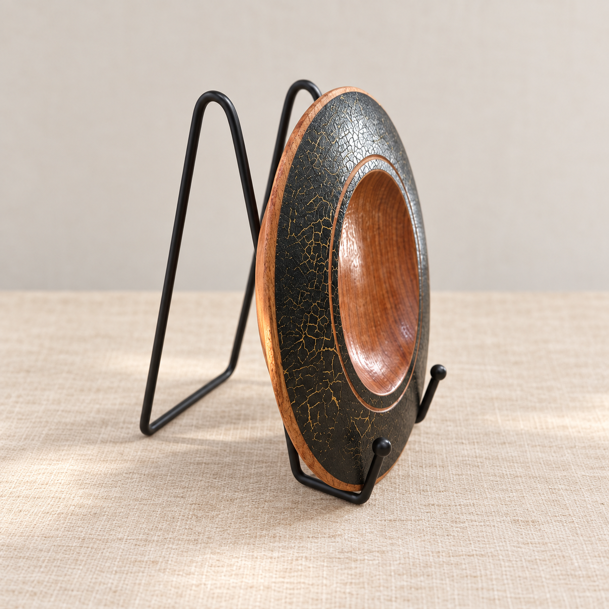 Side view of handmade Silky Oak decorative plate with black metal display stand