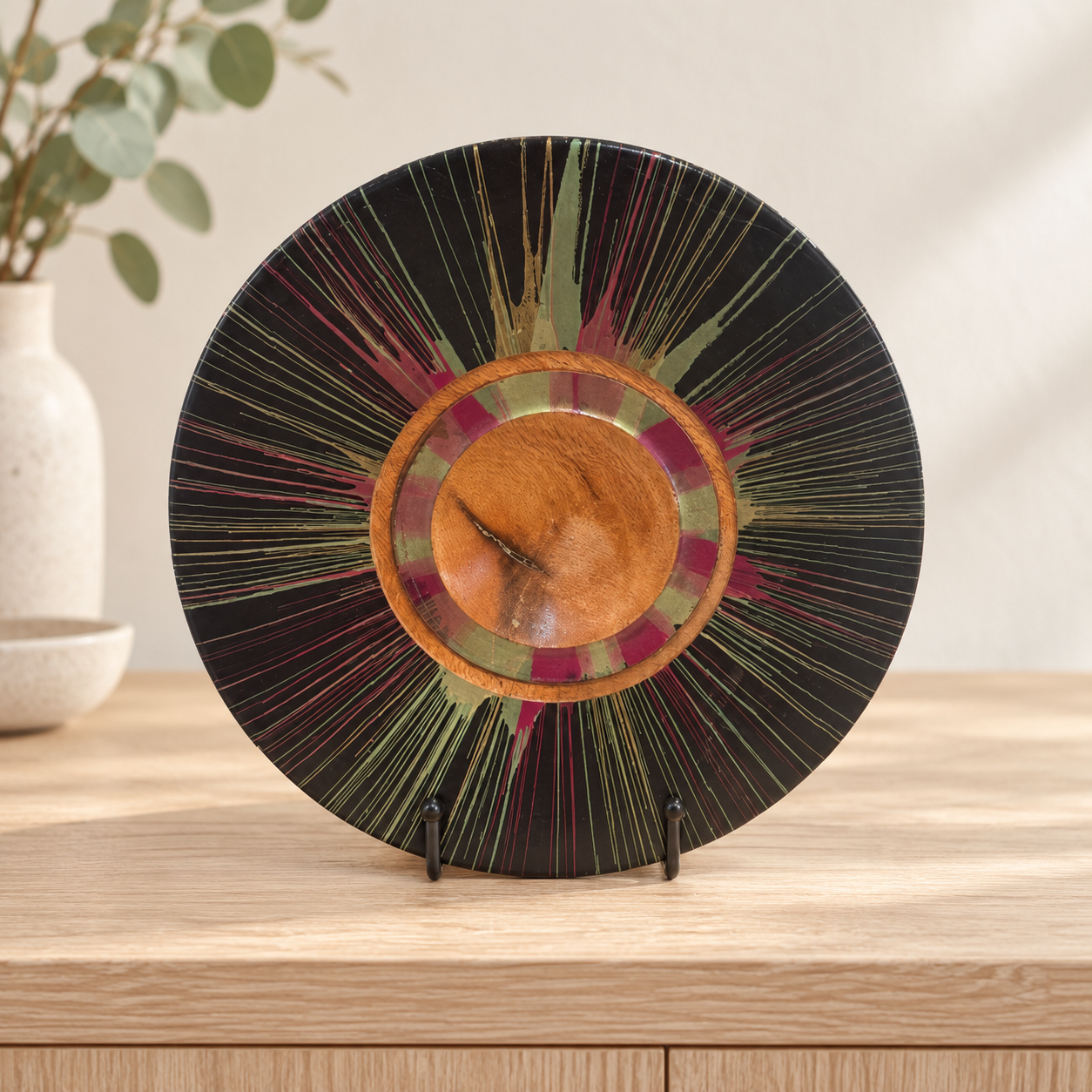 Silky Oak centrifugal decorative plate with display stand facing outward on a timber cabinet
