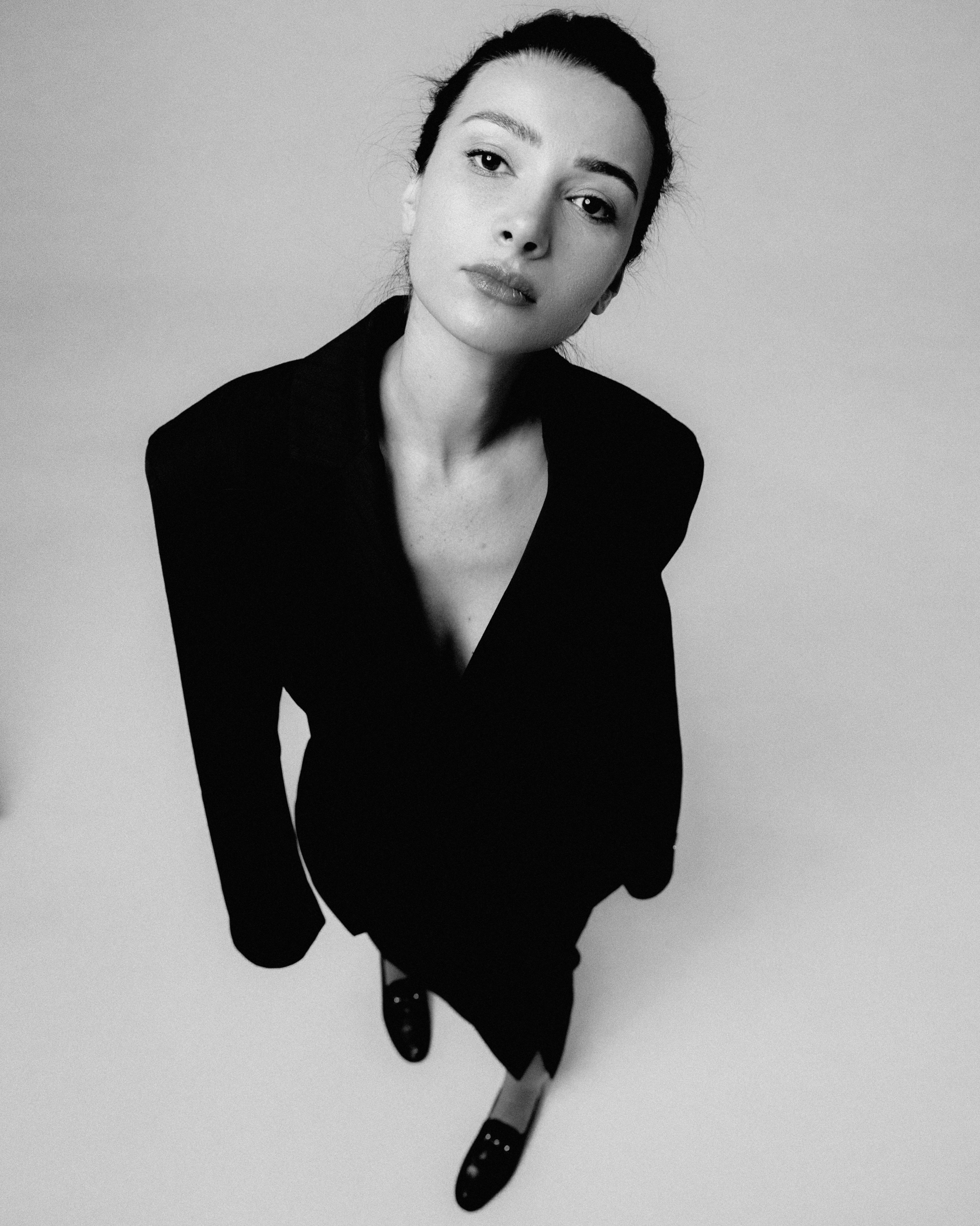 Portrait of contemporary artist Sopiko Grigolashvili in a black blazer, black and white photography