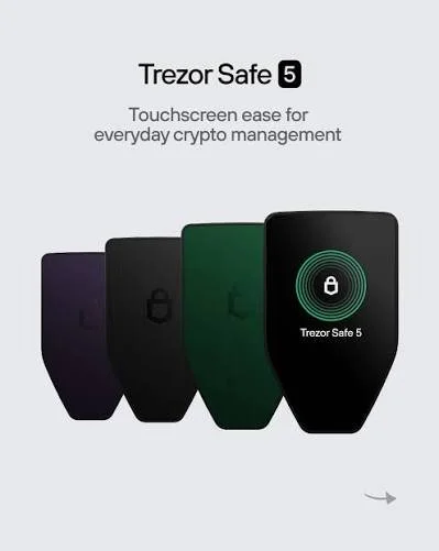 Four Trezor Safe 5 cryptocurrency hardware wallets in purple, black, green, and black with a display showing a lock icon and "Trezor Safe 5".