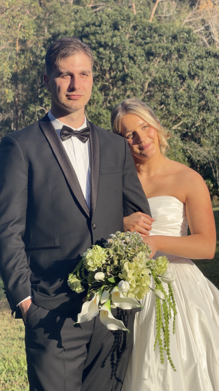 Laurie’s customers, Fernando and Kate embracing by the lake on their wedding day.