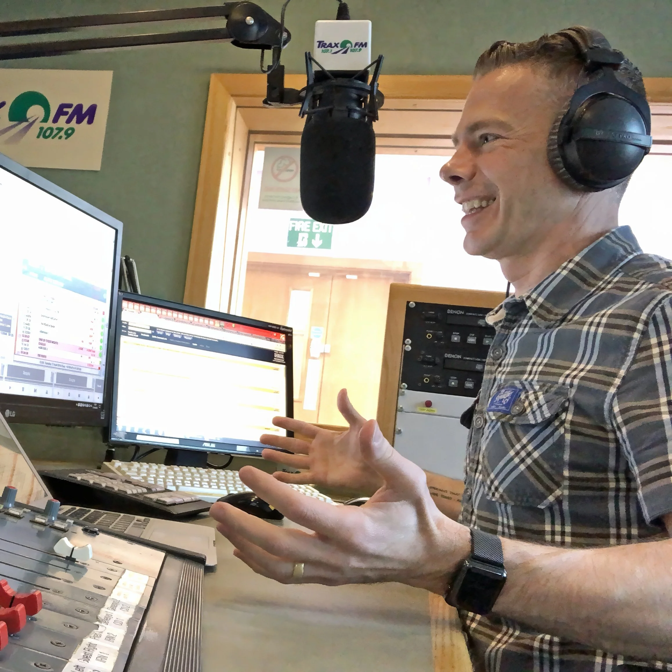 Colin Dobson-Fox presenting live radio in a professional broadcast studio at Trax FM.