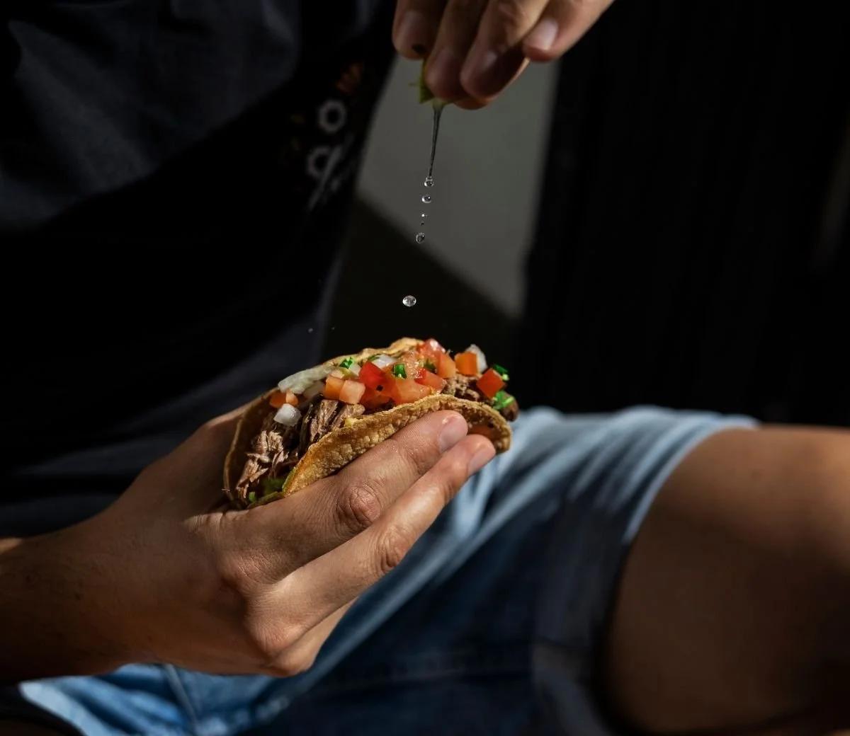 Guest enjoying a freshly filled taco at Six Seis Taquería