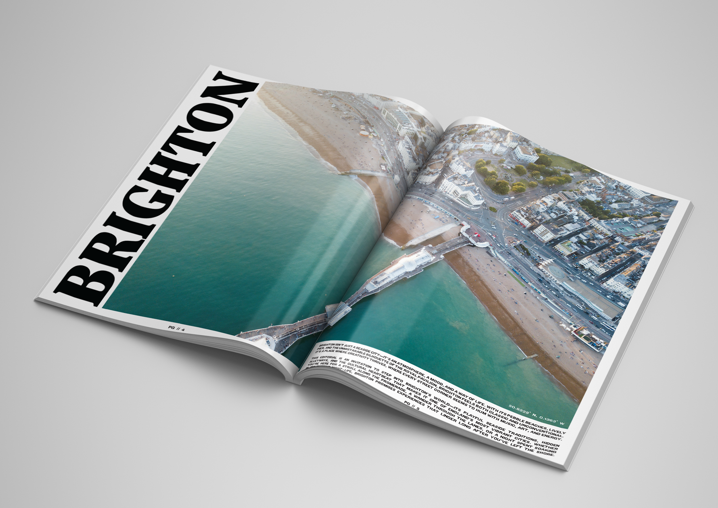 An open magazine showing an aerial view photograph of a coastal city with a beach, pier, and surrounding buildings.