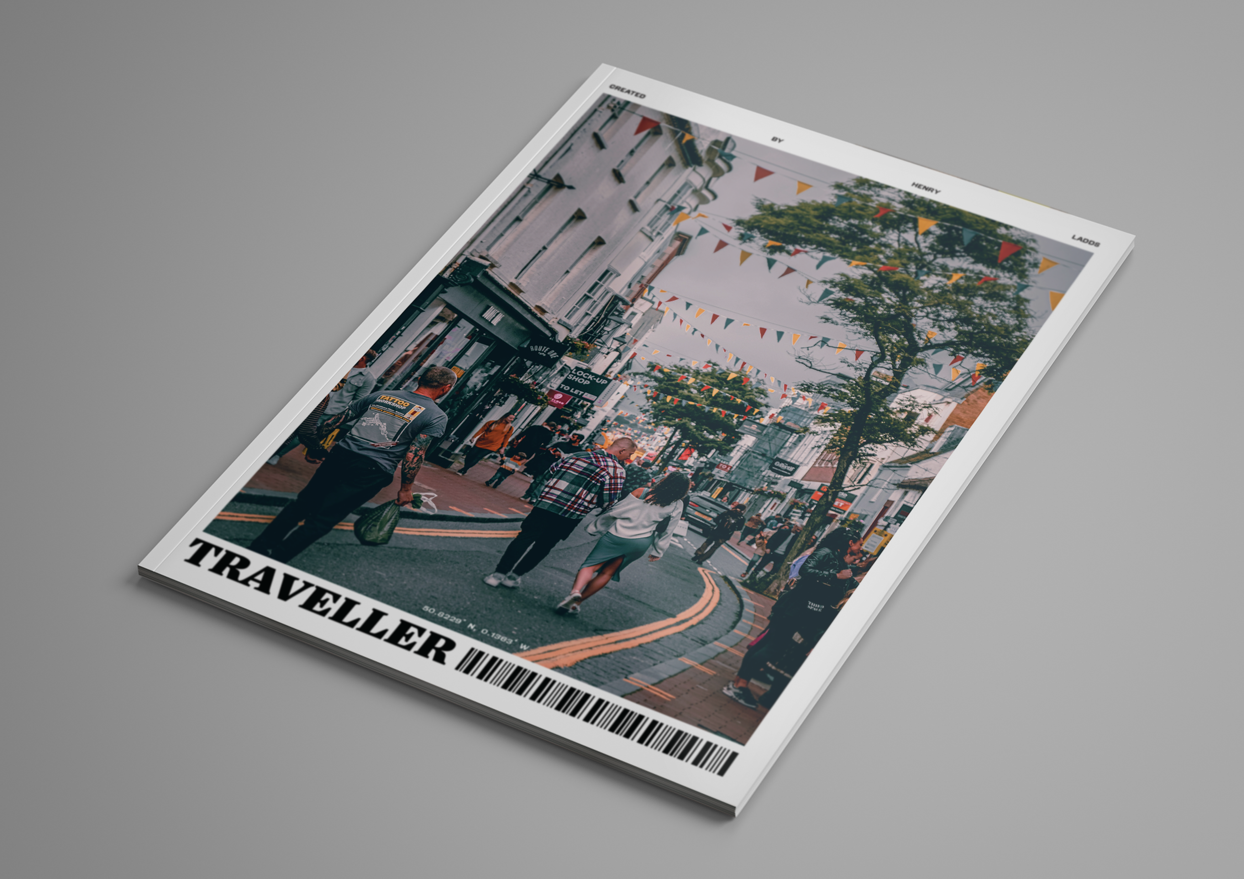Cover of a magazine titled "Travellexer" featuring an outdoor street scene with people walking under string flags and shops along the street, with some trees and buildings in the background.