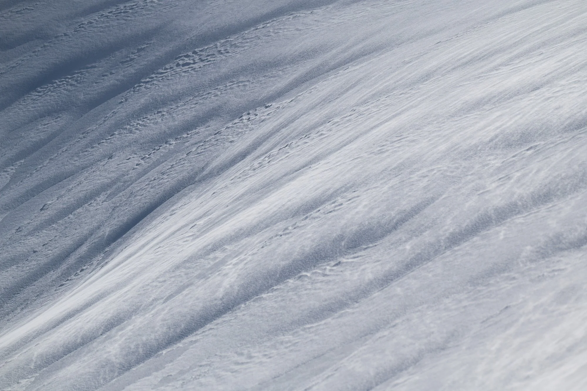 Surface glacière enneigée avec des traces de pas sur la neige.
