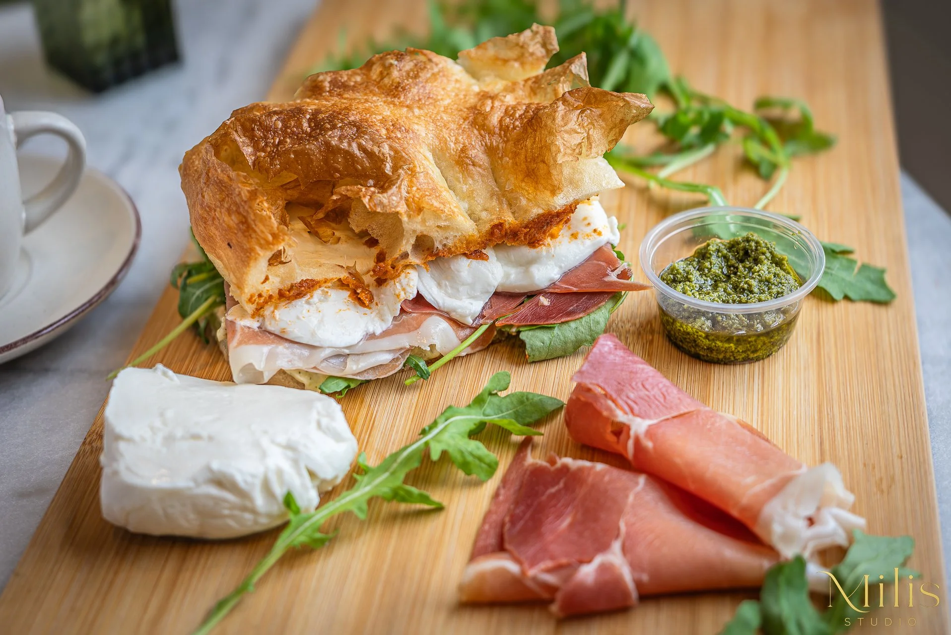 Italian focaccia sandwich with prosciutto and mozzarella photographed by Milis Studio