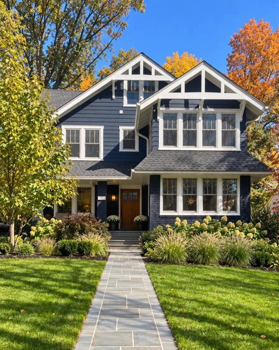 Renovated Montclair, New Jersey home with dark-blue siding, white trim, and a landscaped front yard.