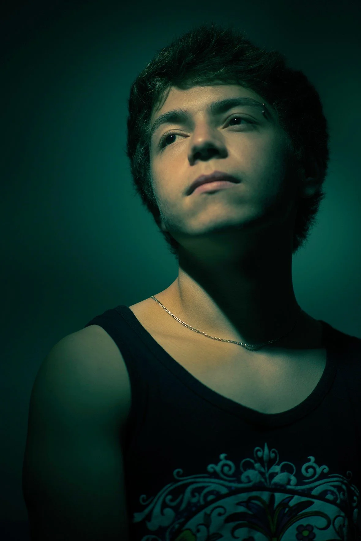 Portrait of a young man in a greenish light.