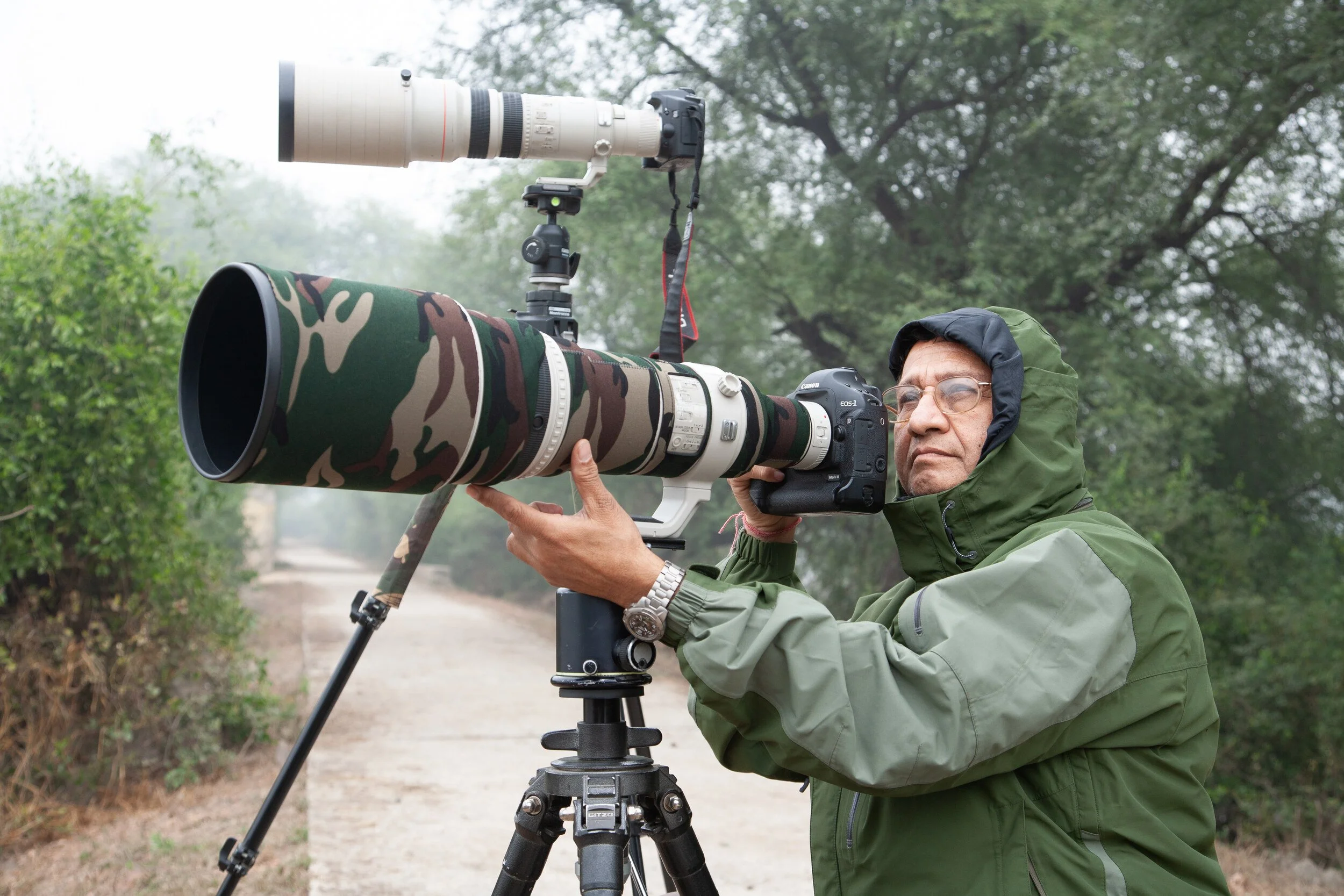 Nanak Dhingra behind a camouflaged 600 mm lens on a tripod