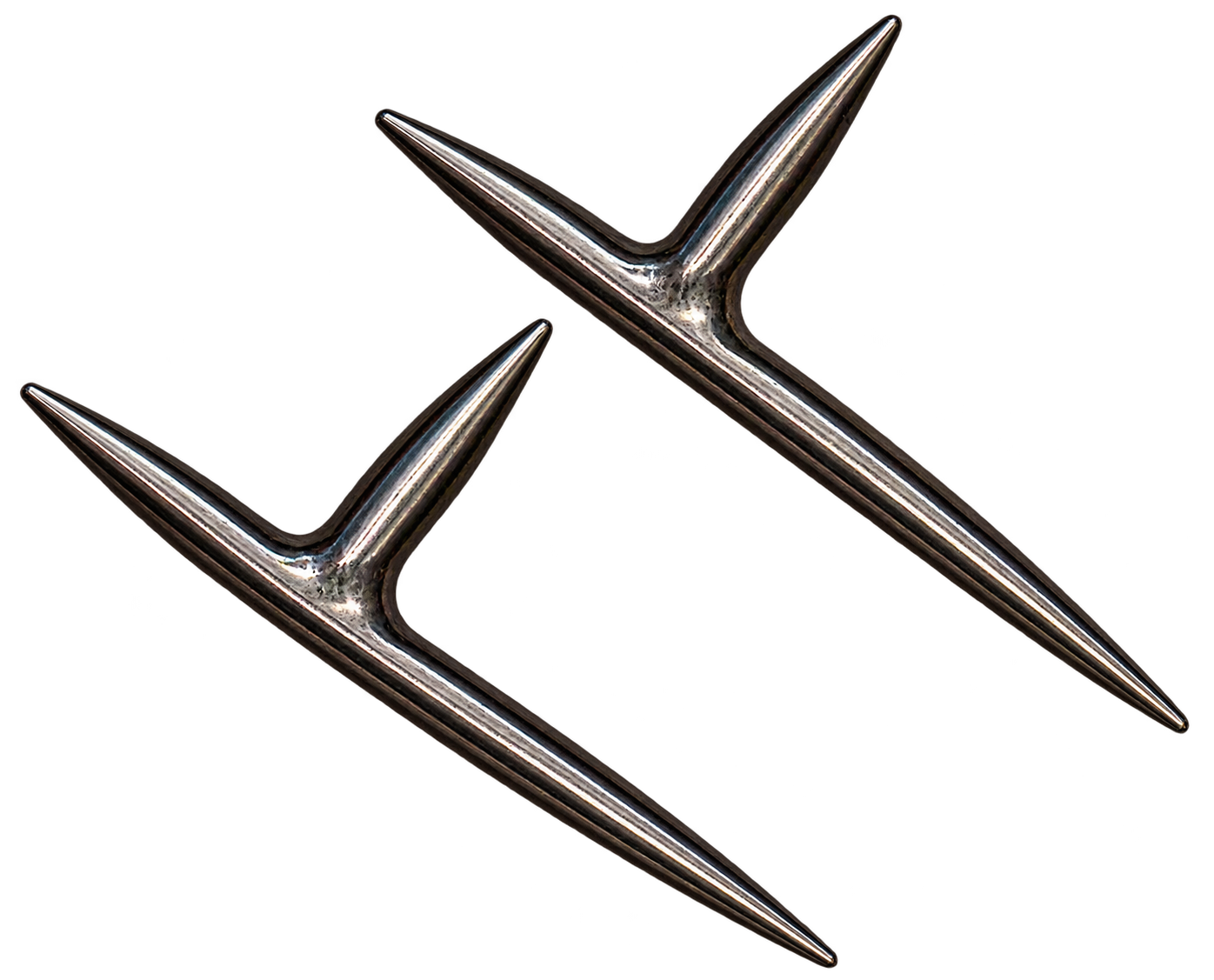 Two shiny, metallic, star-shaped nail pullers with pointed ends, isolated on a black background.