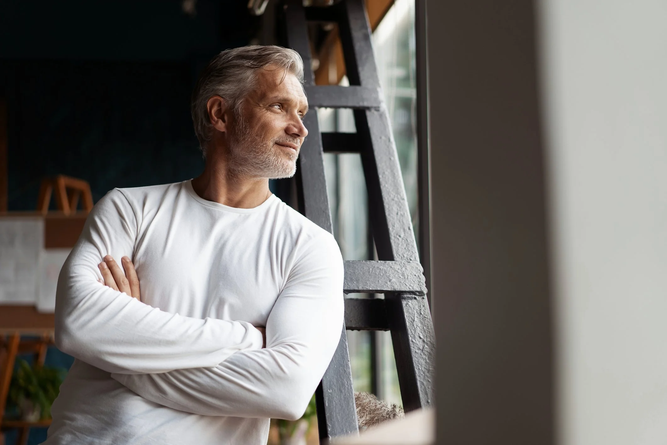 Attractive, fit older man in white shirt, smiling, side profile.