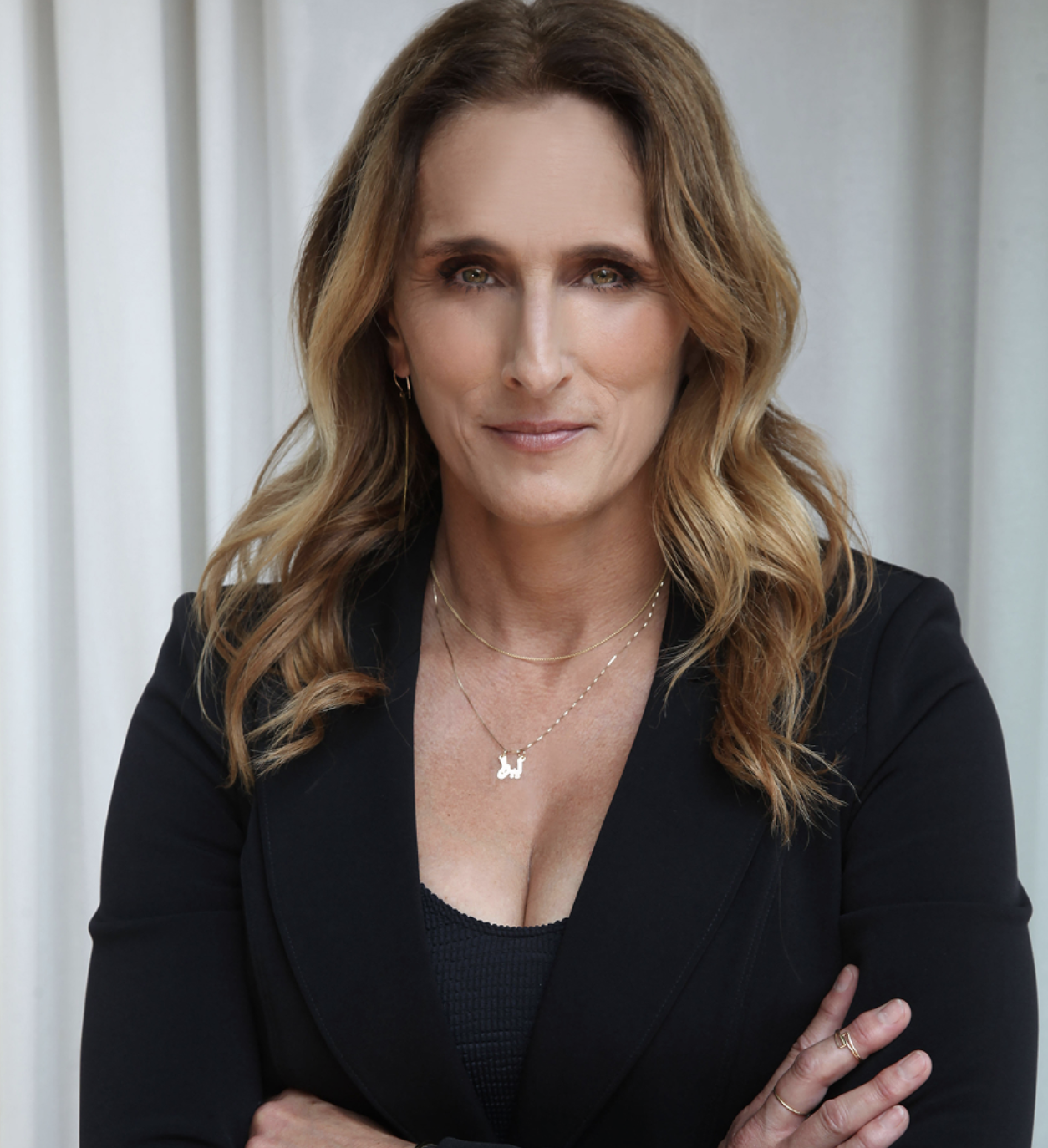 Female executive smiling wearing black dress suit