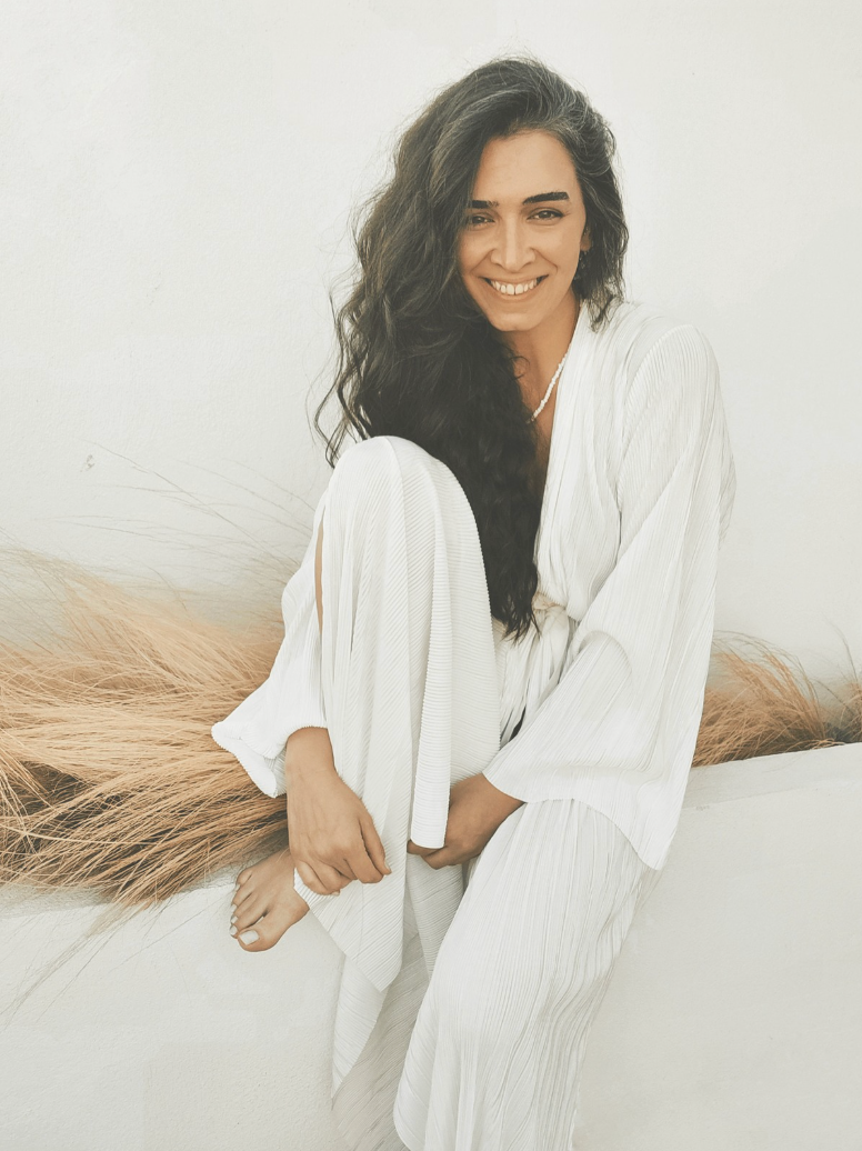 attractive brunette, wavy, long hair in comfortable white clothes, smiling