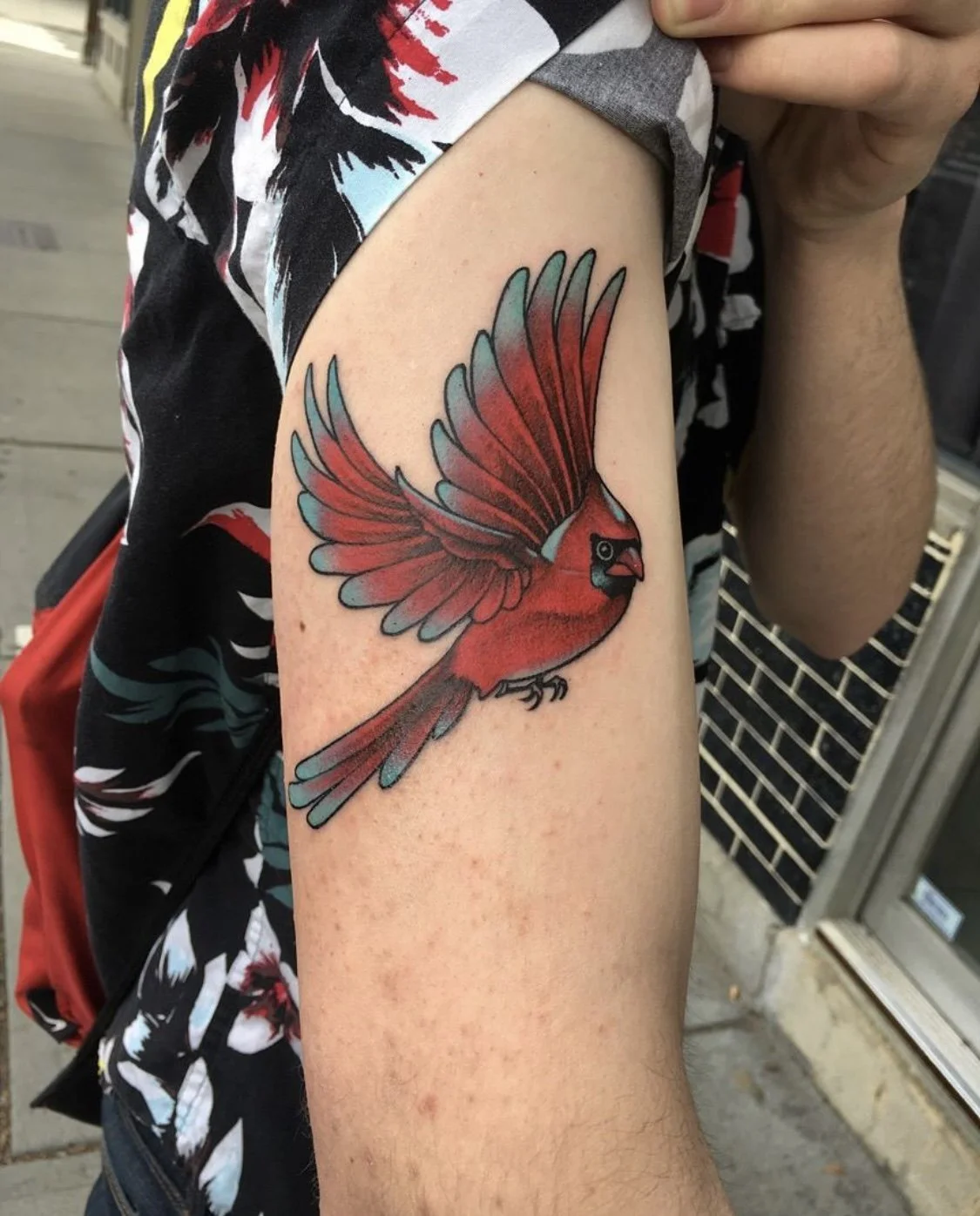 Color red bird in flight tattoo by Gonzalo Chavez