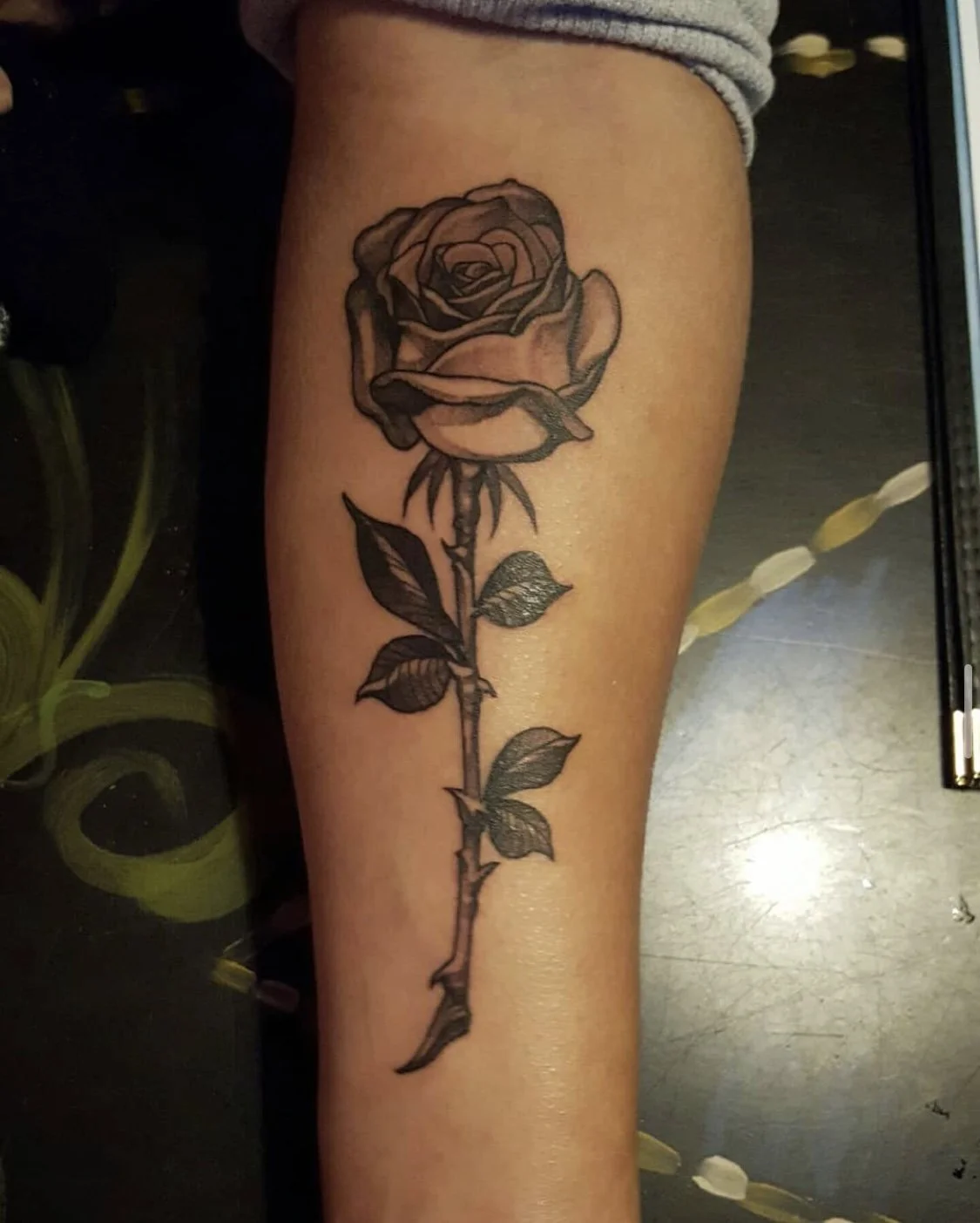 Black and grey illustrated rose tattoo by Gonzalo Chavez