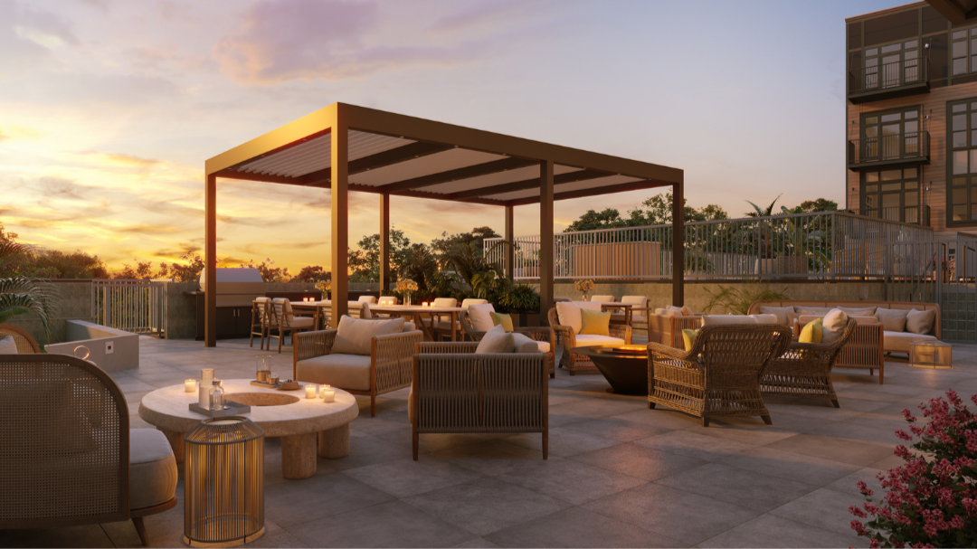 Rooftop lounge with outdoor seating, a fire pit, and a pergola at sunset.