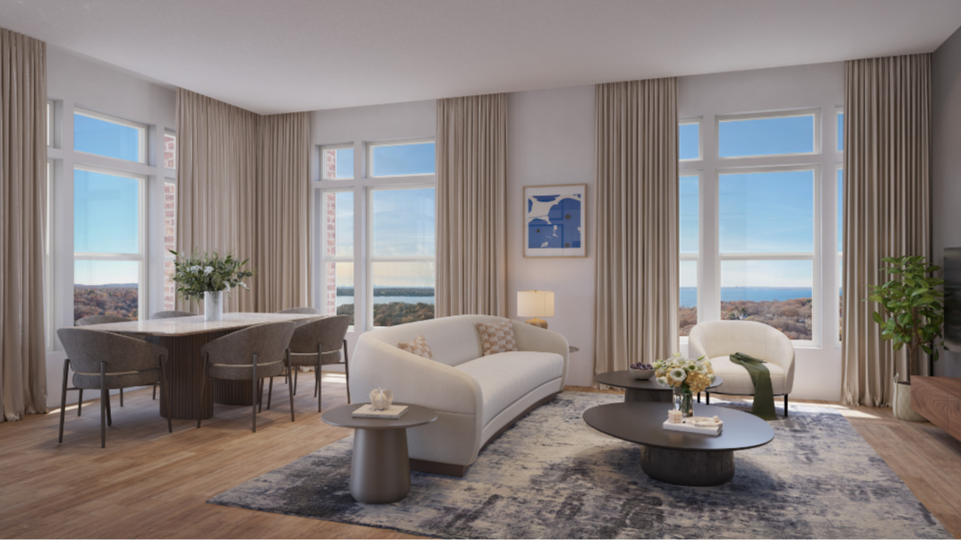 Living room with large windows, beige curtains, white sofa, armchair, modern coffee tables, and a dining table with chairs.