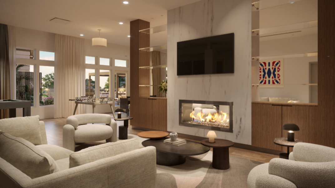 Modern living room with beige sofas, a marble fireplace, a flat-screen TV, and large windows with curtains, overlooking a patio.