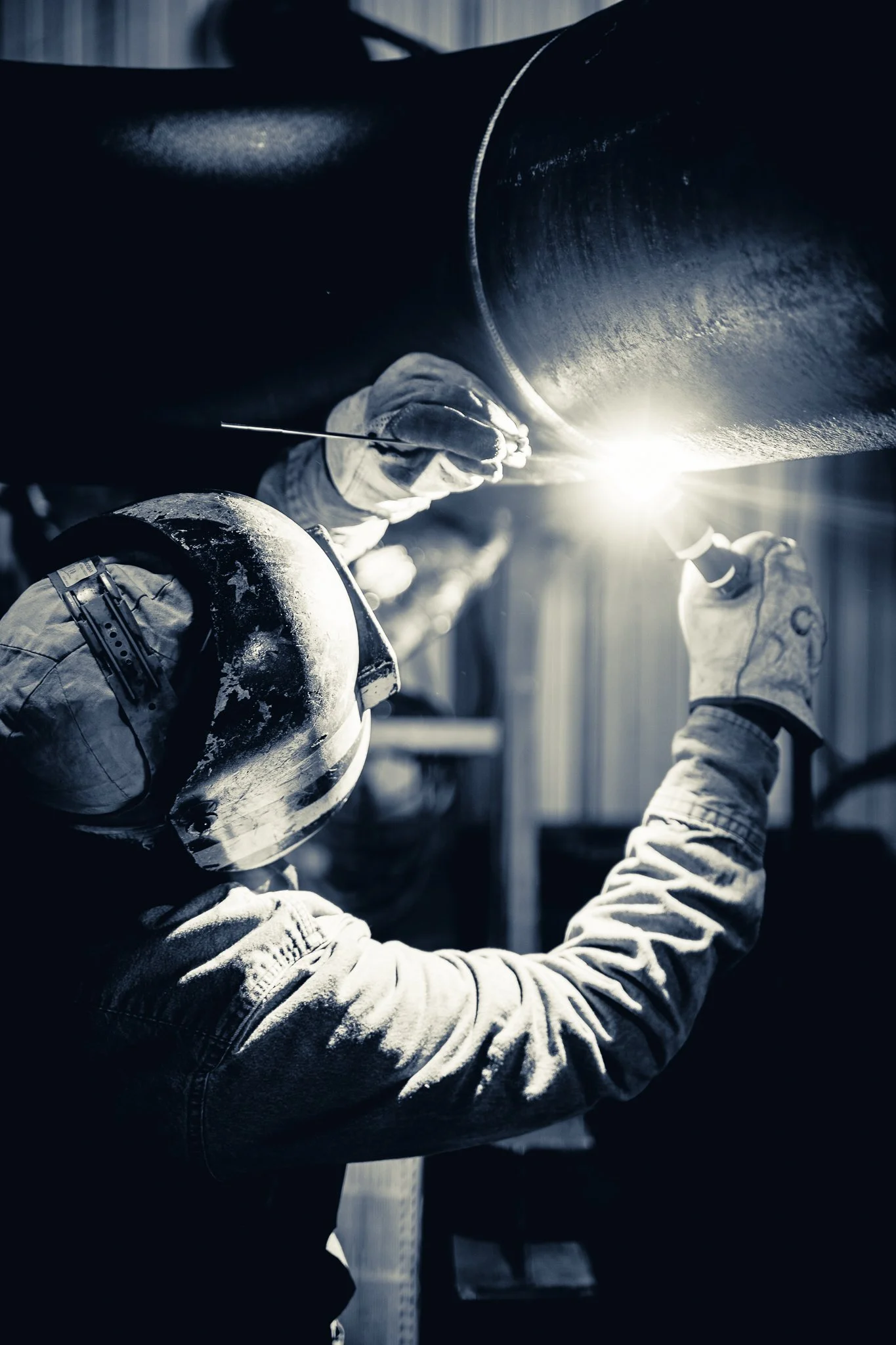 Welder performing precision welding on industrial piping
