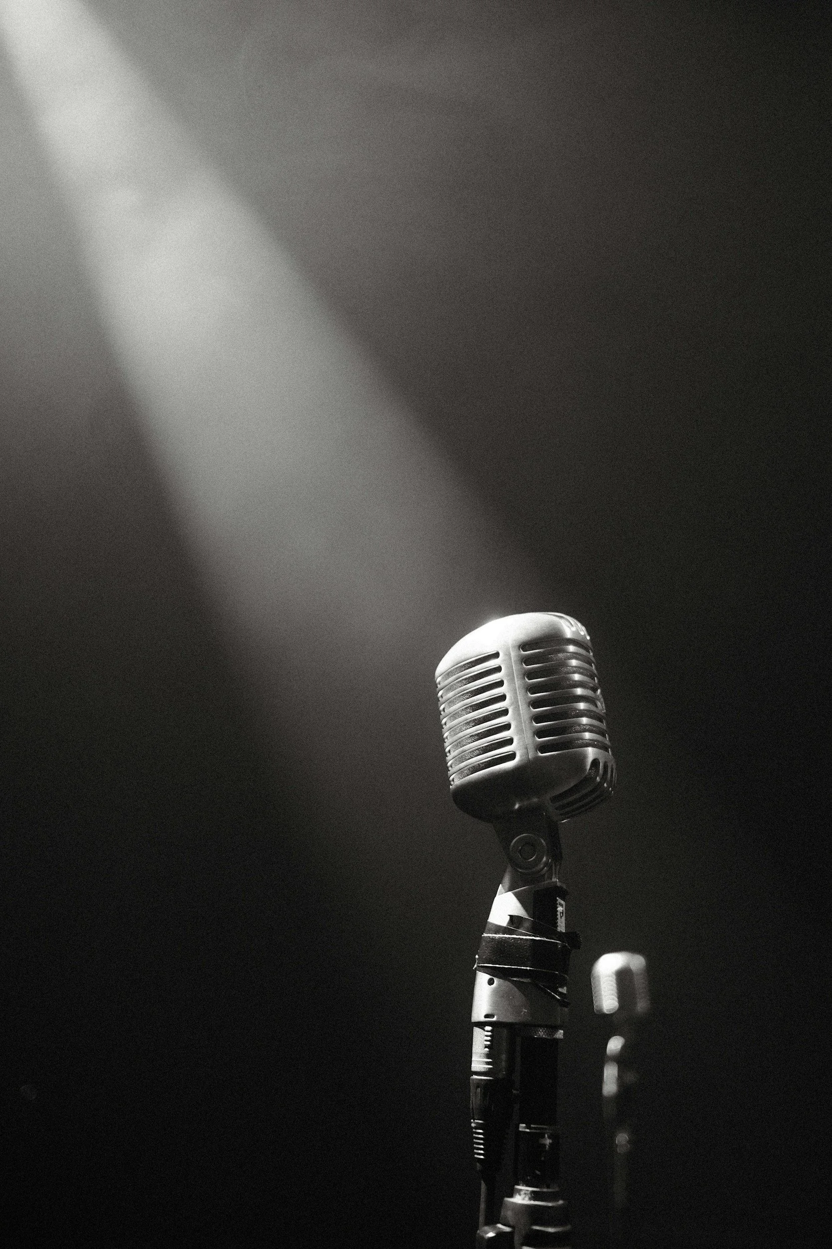 Vintage microphone on a stand with spotlight.