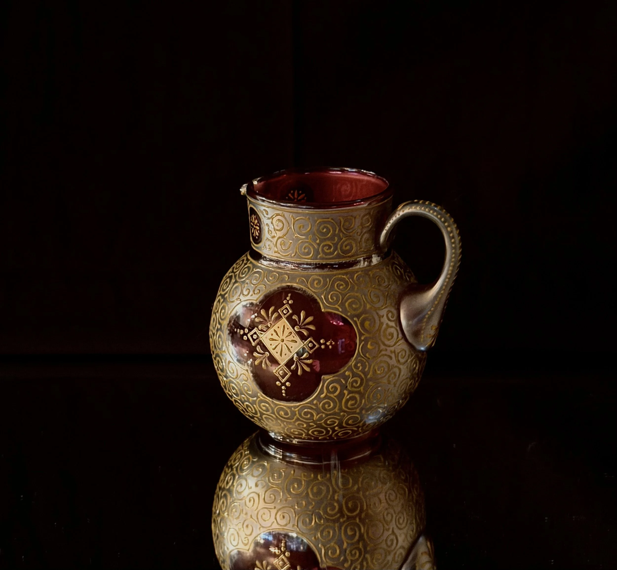 A Moser creamer highly decorated in heavy glit circa 1900-1910