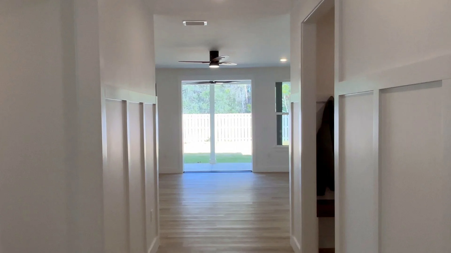Finished hallway with board-and-batten wainscoting and LVP floors in a new Element Homes build in Bay County, Florida