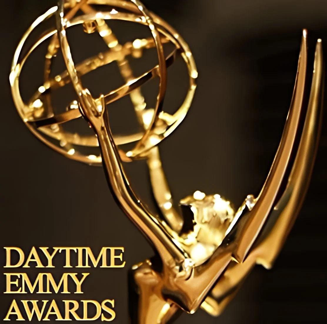 A close-up of a golden Emmy award trophy with the text "DAYTIME EMMY AWARDS" in gold lettering at the bottom left.