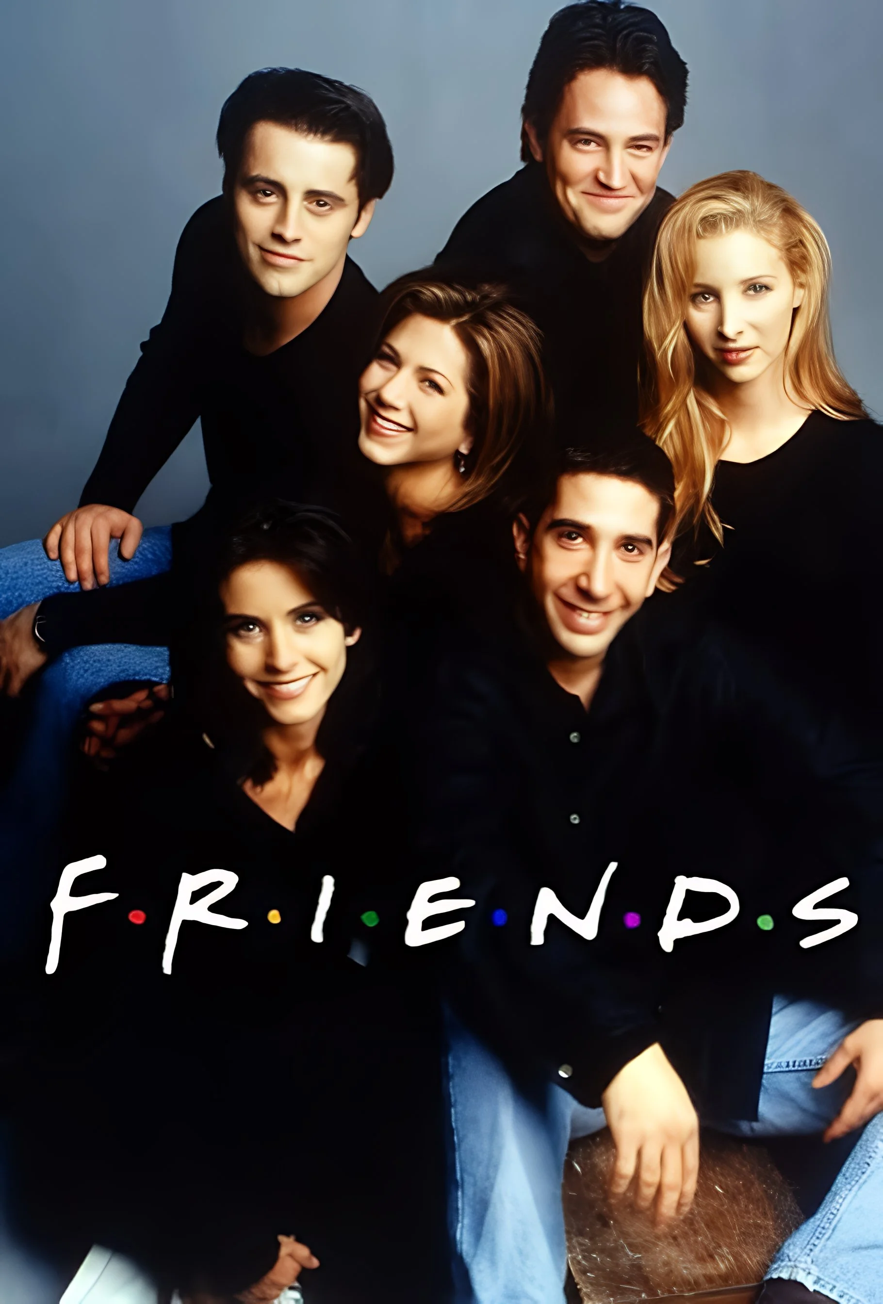A group of six young adults gathered together, wearing black shirts, with the word "FRIENDS" written across the bottom of the image with colorful dots between the letters.