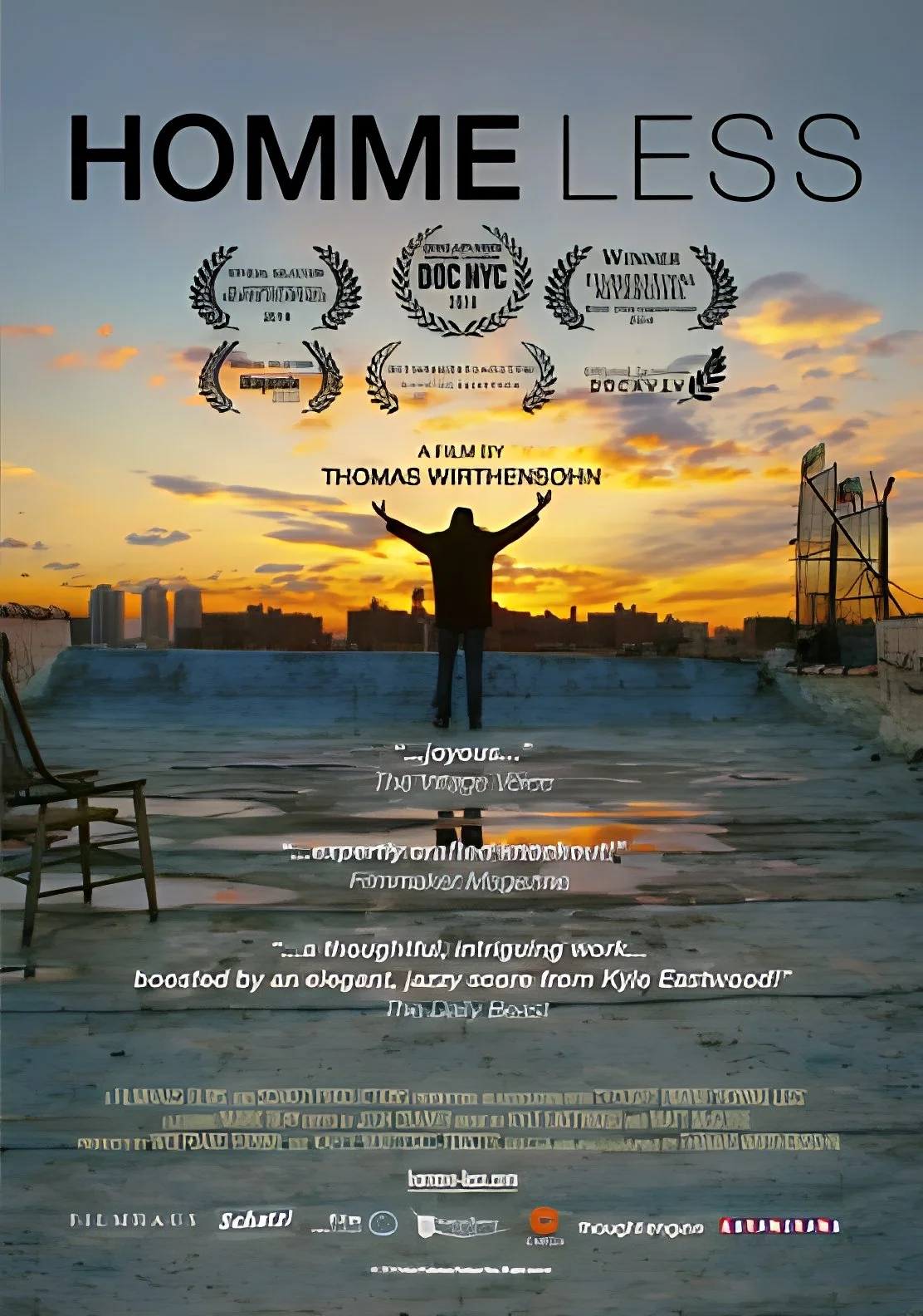 A silhouette of a man standing on a rooftop with arms raised, facing a colorful sunset sky. Overlaid text includes various awards and a quote. The rooftop shows some chairs and cityscape around.