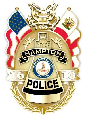 A badge for the City of Hampton Police in Virginia, featuring the American flag, Virginia state flag, the Great Seal of the United States, and the year 2010, with a gold wreath surrounding the badge.