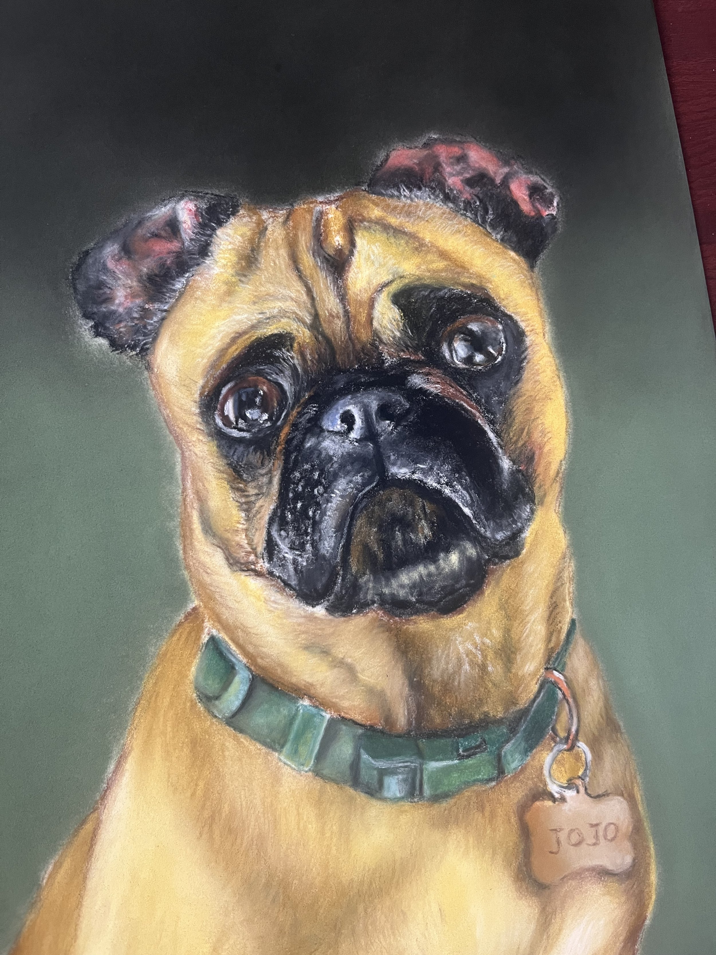 Painting of a fawn-colored pug dog wearing a green collar and a chain leash, with the name 'Jojo' on its collar, set against a dark green background.