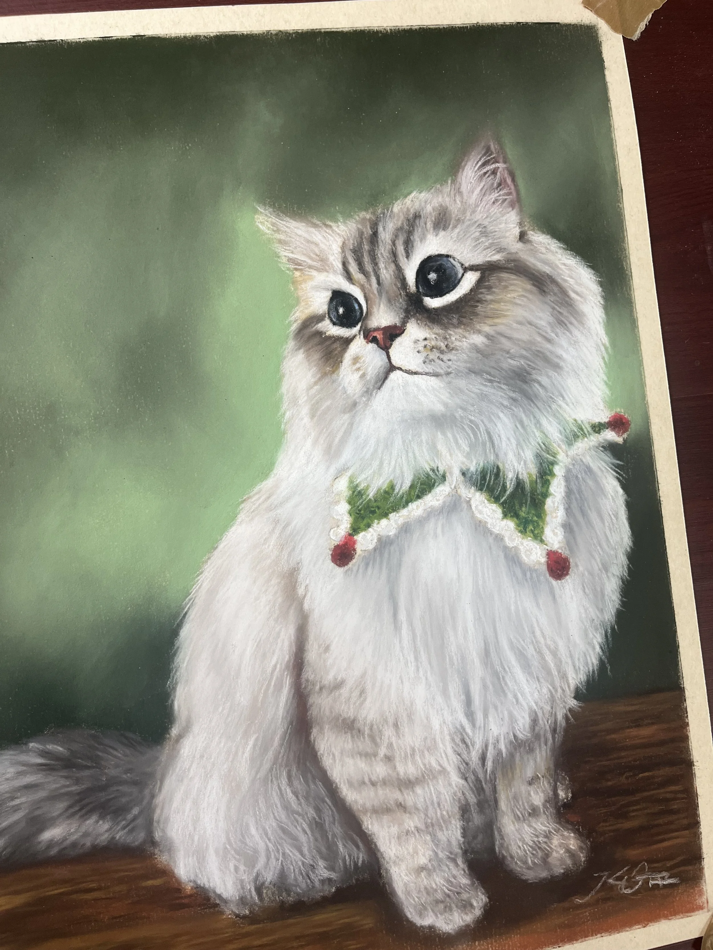 A realistic painting of a fluffy white cat, with a Christmas wreath around its neck, standing on a wooden floor with a green background.