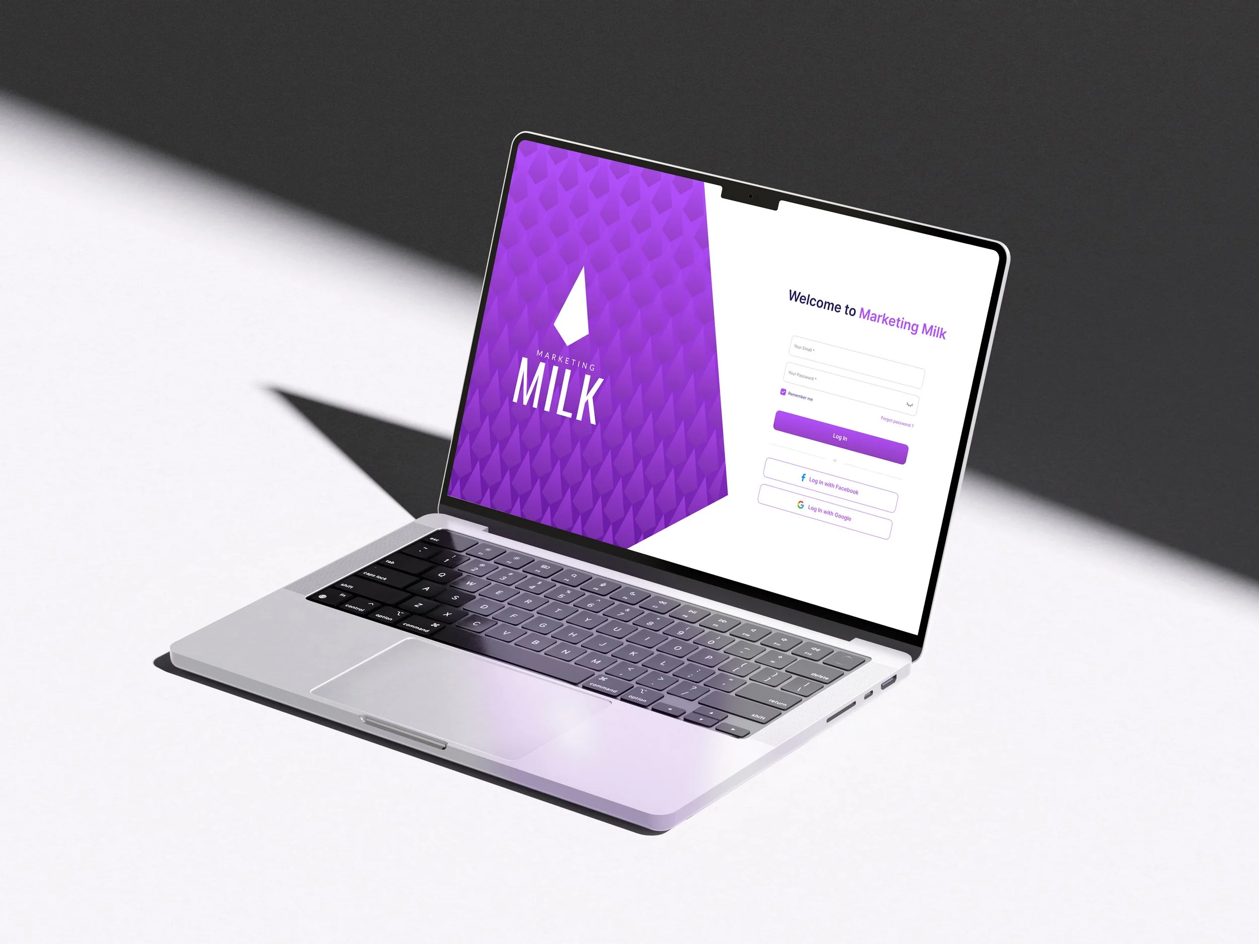 Laptop displaying a login screen with a purple-themed background and the words 'Welcome to Marketing Milk'.