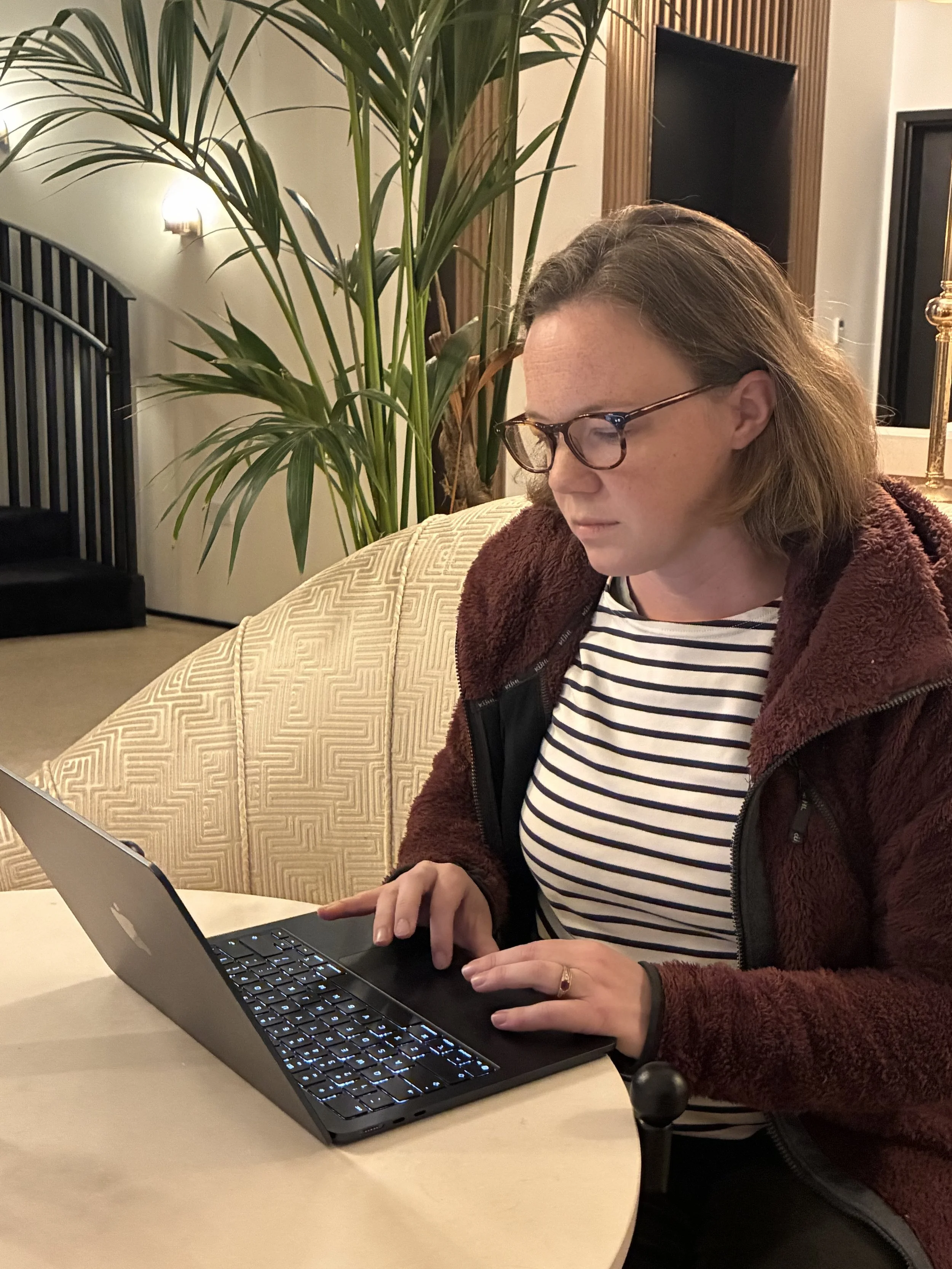 Female web designer seated in front of a laptop