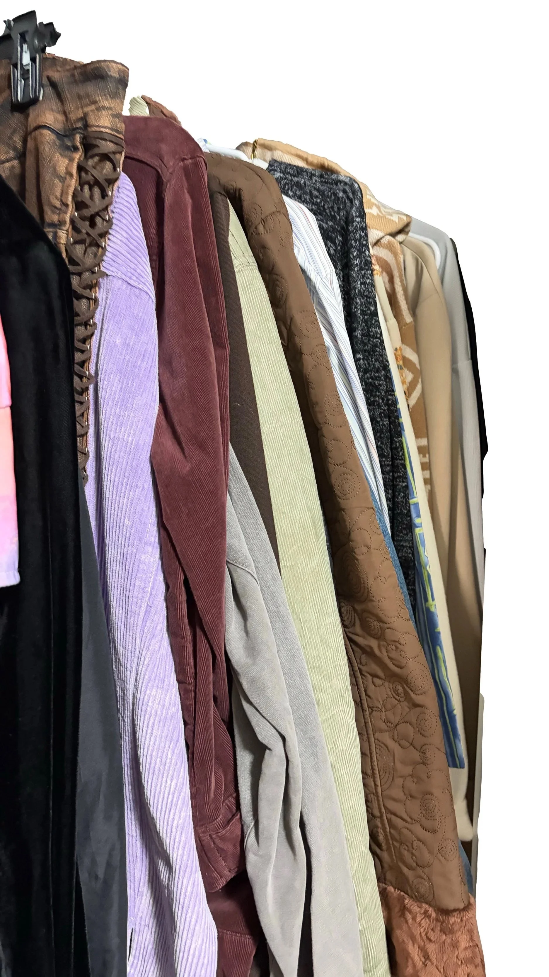 A row of various colored and patterned jackets hanging on a clothing rack.