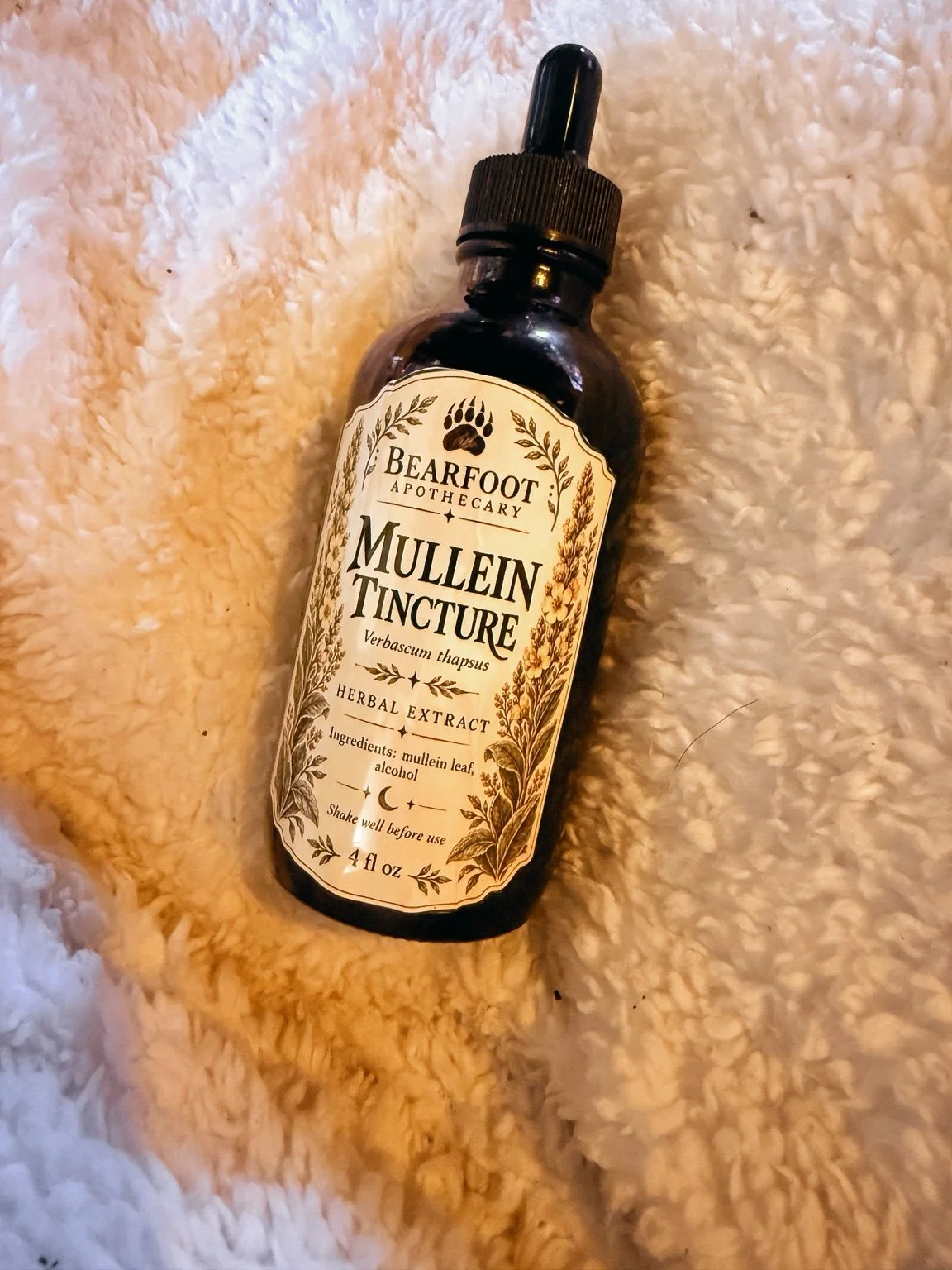 Bearfoot Apothecary mullein tincture herbal extract bottle on a fluffy blanket