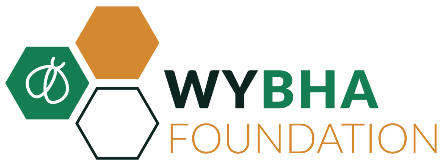 Logo for WYBHA Foundation featuring three hexagons, one with a white leaf icon on green, one solid gold, and one outlined black, with the words "WYBHA Foundation" next to the hexagons.